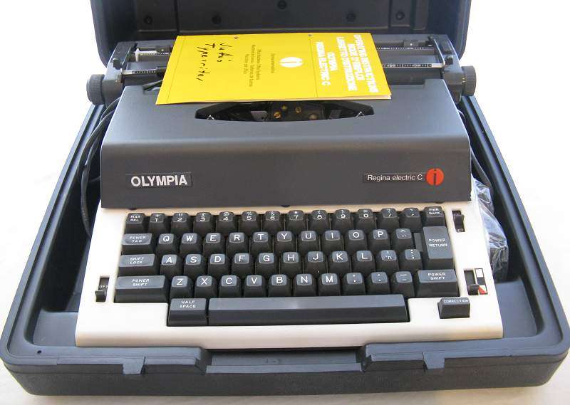 OLYMPIA - REGINA ELECTRIC C TYPEWRITER W/ OPERATING INSTUCTIONS & CASING.