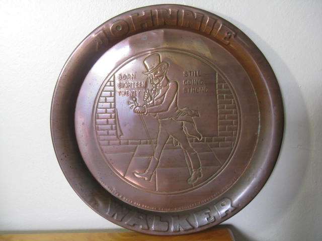 JOHNNIE WALKER COPPER TRAY, BORN 1820 - STILL GOING STRONG. D 33.8cm.