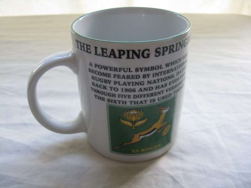 THE LEAPING SPRINBOK HISTORY MUG. H 9.4cm.