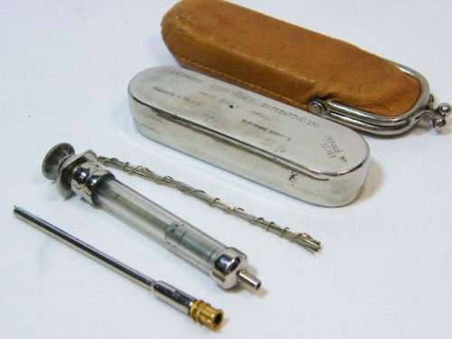 Vintage syringe in tin case with leather pouch