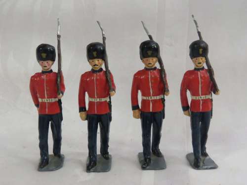 Set of 4 British guards marching with rifle lead soldiers