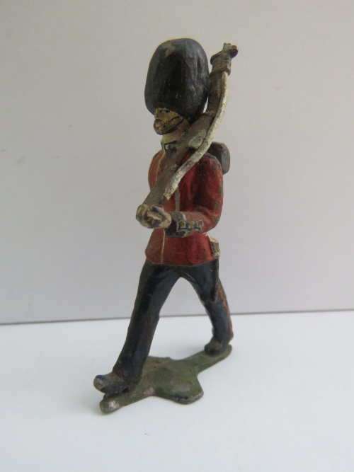 Vintage British lead soldier marching with rifle