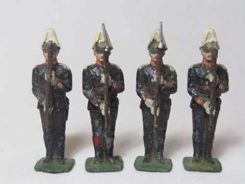 Set of 4 vintage lead soldiers on attention with rifles