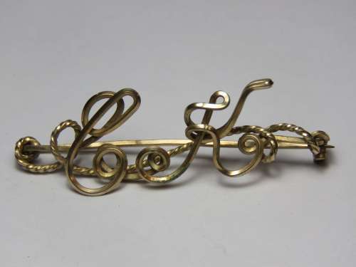 Gold colour brooch with initial CK