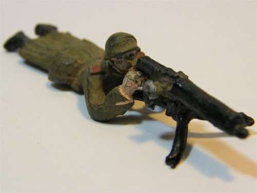 Vintage machine gunner lead soldier laying