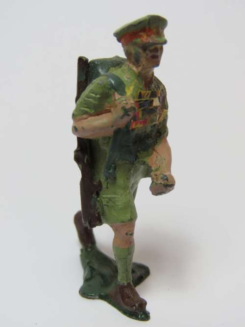 Vintage lead toy soldier hiking with rifle