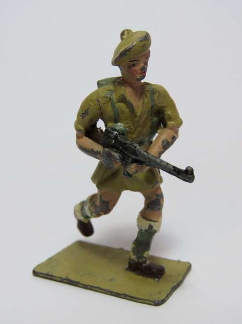 Vintage lead soldier running with machine gun