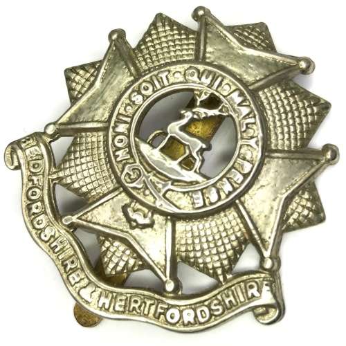 The Bedfordshire and Hertfordshire regiment cap badge with slide