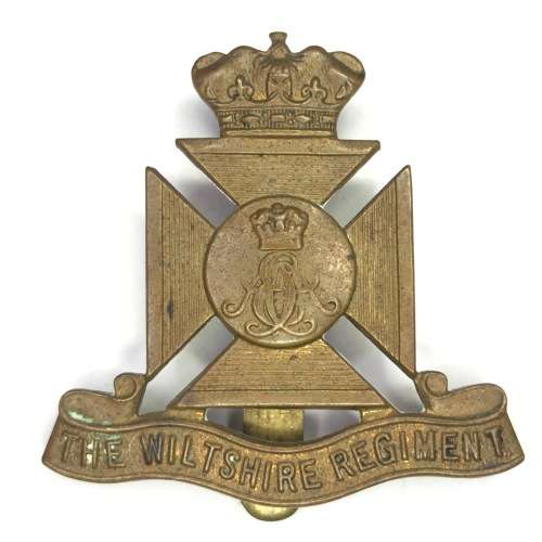 The Wiltshire regiment cap badge with slide