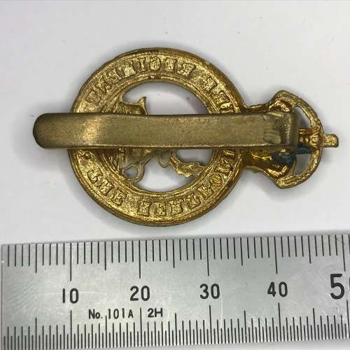 The Hertfordshire regiment cap badge with slide