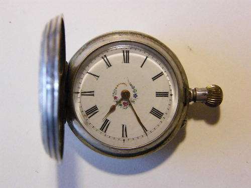 Silver ladies pocketwatch with flower pattern on dial, overwounded