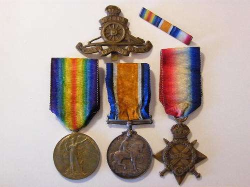 Set of WW1 medals plus ribbon bar and Royal Artillery cap badge to 362 DVR L.R. Marshall R.F.A