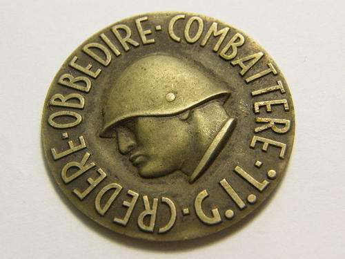 WW2 Italian badge with Mussolini ' Credere Obbedire Combattere ' - no pins - as per photo