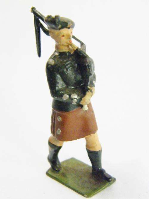 Vintage Highlanders lead soldier playing bag pipes - as per photo