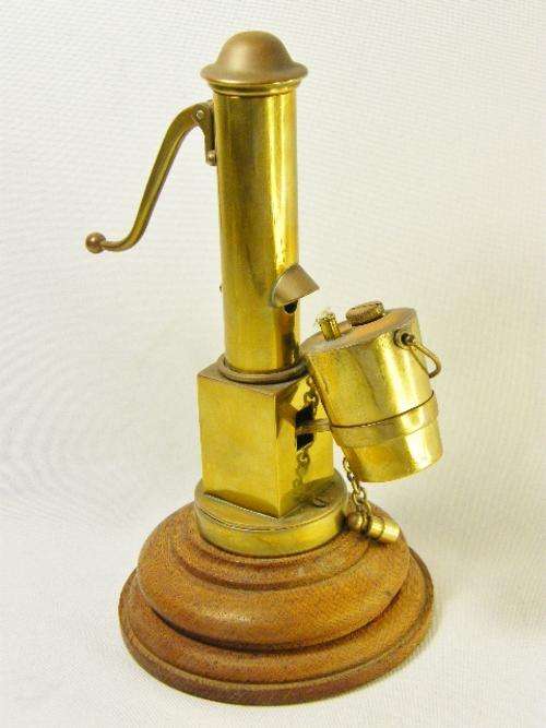 Antique brass table lighter in shape of antique water pump - as per photo