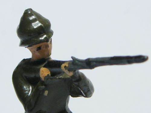 Vintage Scottish lead soldier shooting his rifle - as per photo
