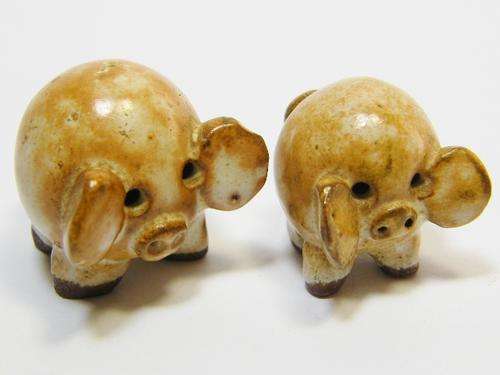 Pair of small vintage porcelain pigs with hollow eyes - as per photo