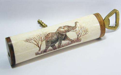 Corkscrew and bottle opener tool with antique bone and wood handle - scrimshaw artwork of elephant