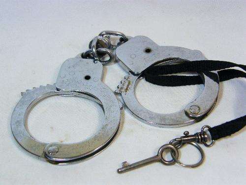 Pair of vintage Police handcuffs with key - as per photo