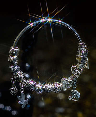 Silver plated, solid bracelet, 64mm width, with 14 charms