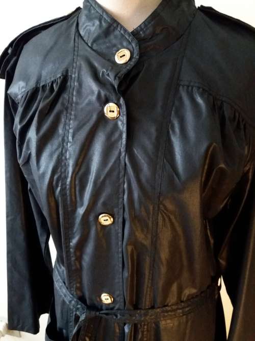 Long black raincoat with copper buttons