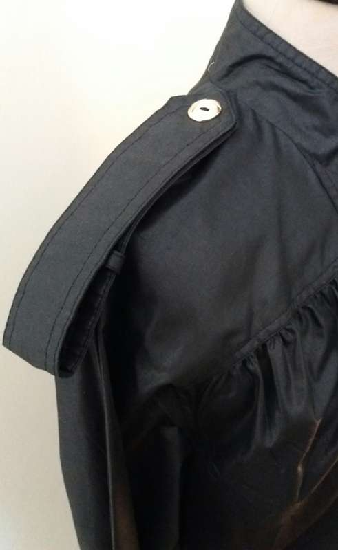 Long black raincoat with copper buttons