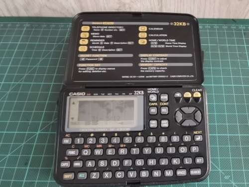 Vintage Casio personal digital organizer with manual