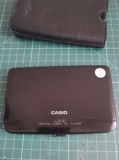 Vintage Casio personal digital organizer with manual