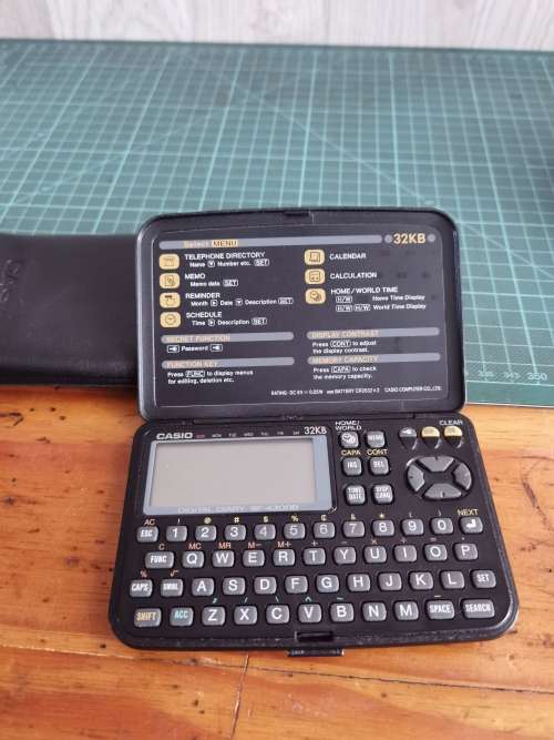 Vintage Casio personal digital organizer with manual
