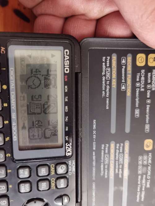 Vintage Casio personal digital organizer with manual