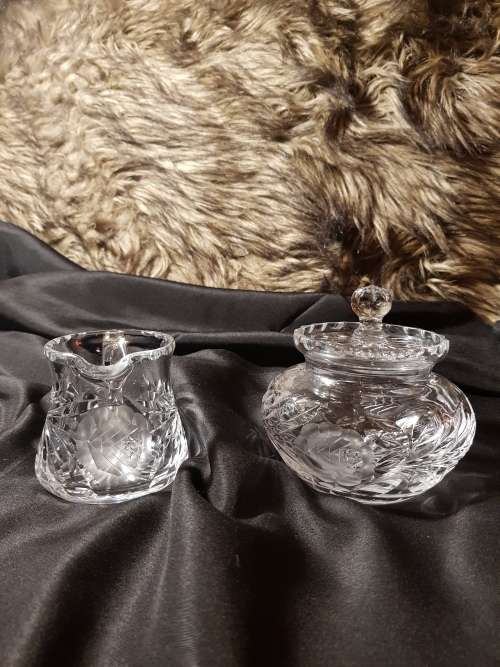 Set of fine cut crystal lidded sugar bowl and milk jug