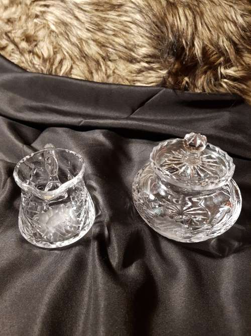 Set of fine cut crystal lidded sugar bowl and milk jug