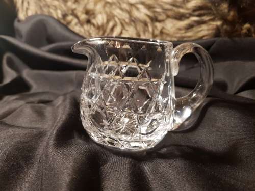Set of fine cut crystal lidded sugar bowl and milk jug