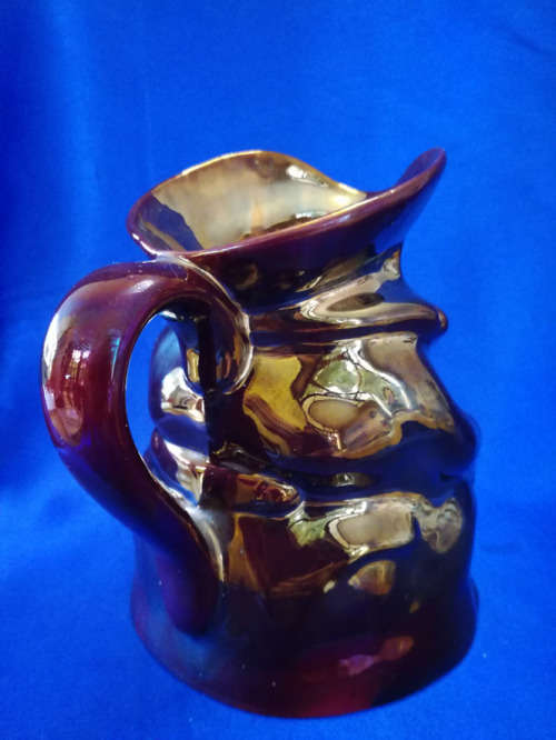 An extremely rare brown bronze luster Toby jug by Roddy ware of Staffordshire England