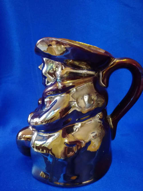An extremely rare brown bronze luster Toby jug by Roddy ware of Staffordshire England