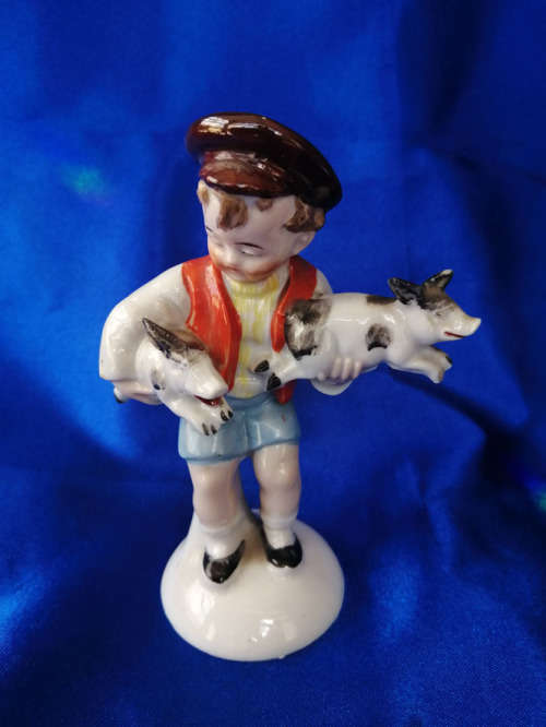 Old Foreign Bisque boy holding two pigs *