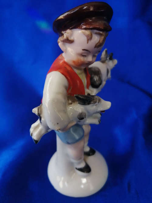Old Foreign Bisque boy holding two pigs *