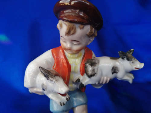 Old Foreign Bisque boy holding two pigs *