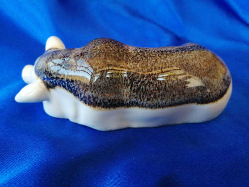 Cream and Brown Porcelain Lying Pig *