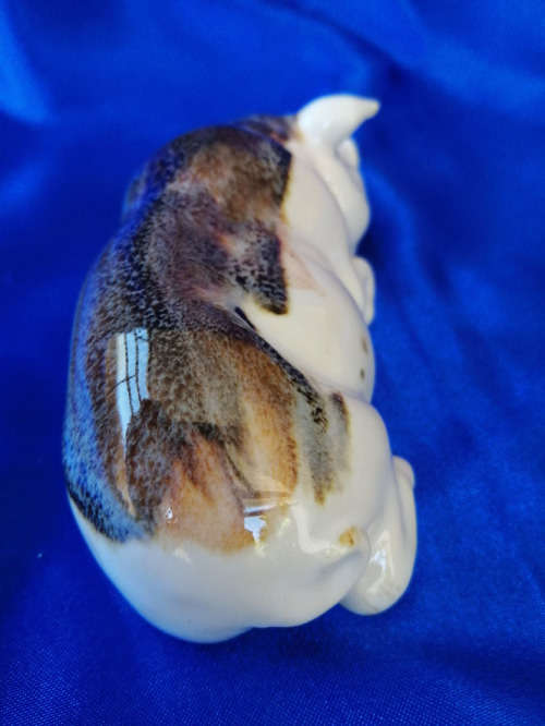 Cream and Brown Porcelain Lying Pig *