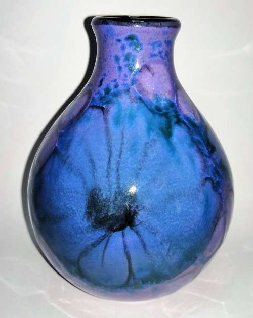 A stunning blend of blue, indigo and violet glazes, this eye-catching Vase by Poole