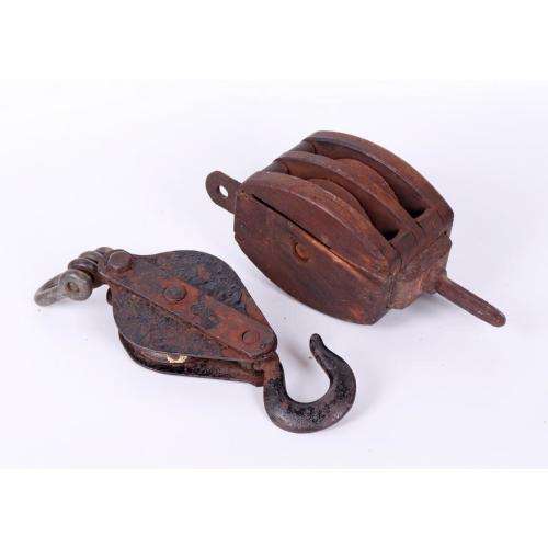 Vintage cast iron and oak pulley and a cast iron pulley