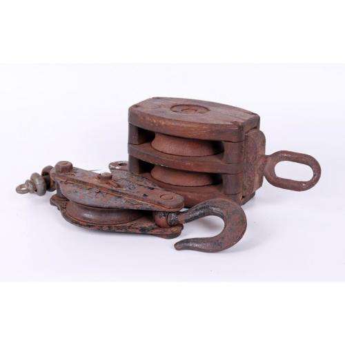 Vintage cast iron and oak pulley and a cast iron pulley