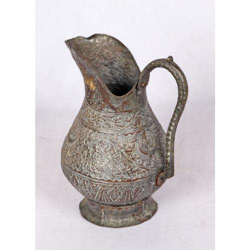 Antique Persian silvered copper jug densely decorated with foliage