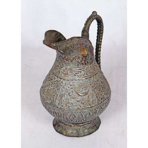 Antique Persian silvered copper jug densely decorated with foliage
