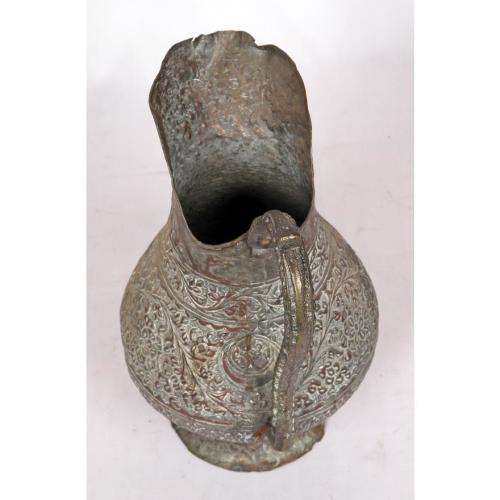 Antique Persian silvered copper jug densely decorated with foliage