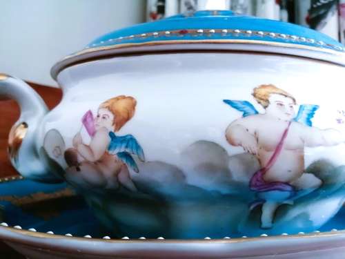 Sevres-style two-handled tureen and stand decorated with cherubs