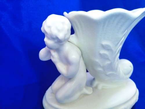 Staffordshire Heirloom Cherub Figurine Next to Vase