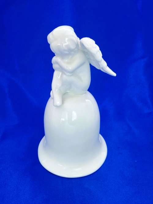 Continental blanc de chine Bell with Cherub sat on top