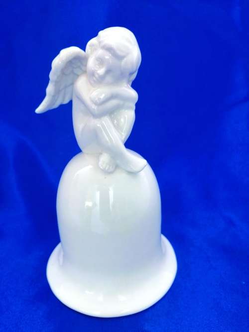 Continental blanc de chine Bell with Cherub sat on top